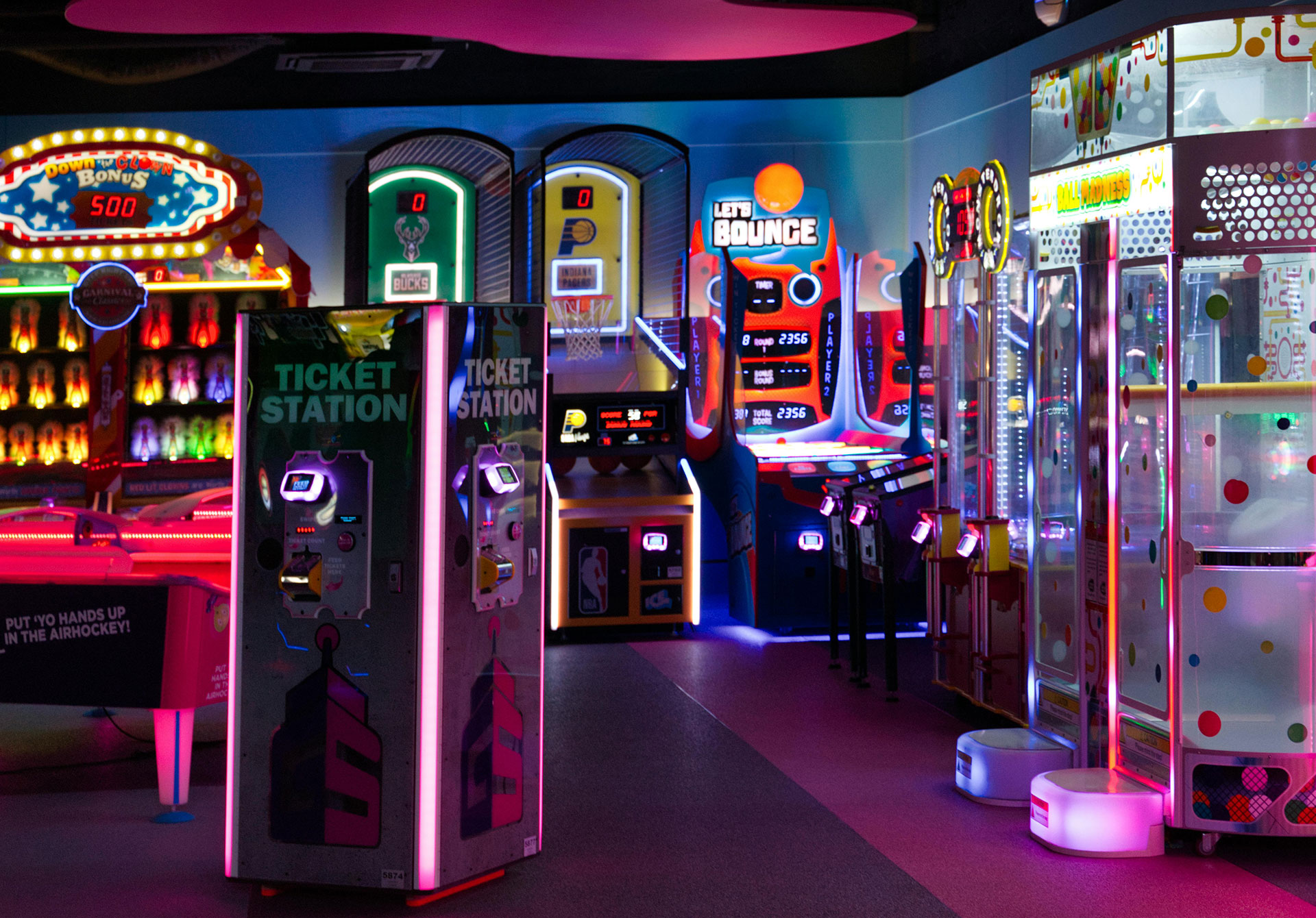 Colorful arcade games and ticket stations create a vibrant atmosphere in a fun entertainment center.
